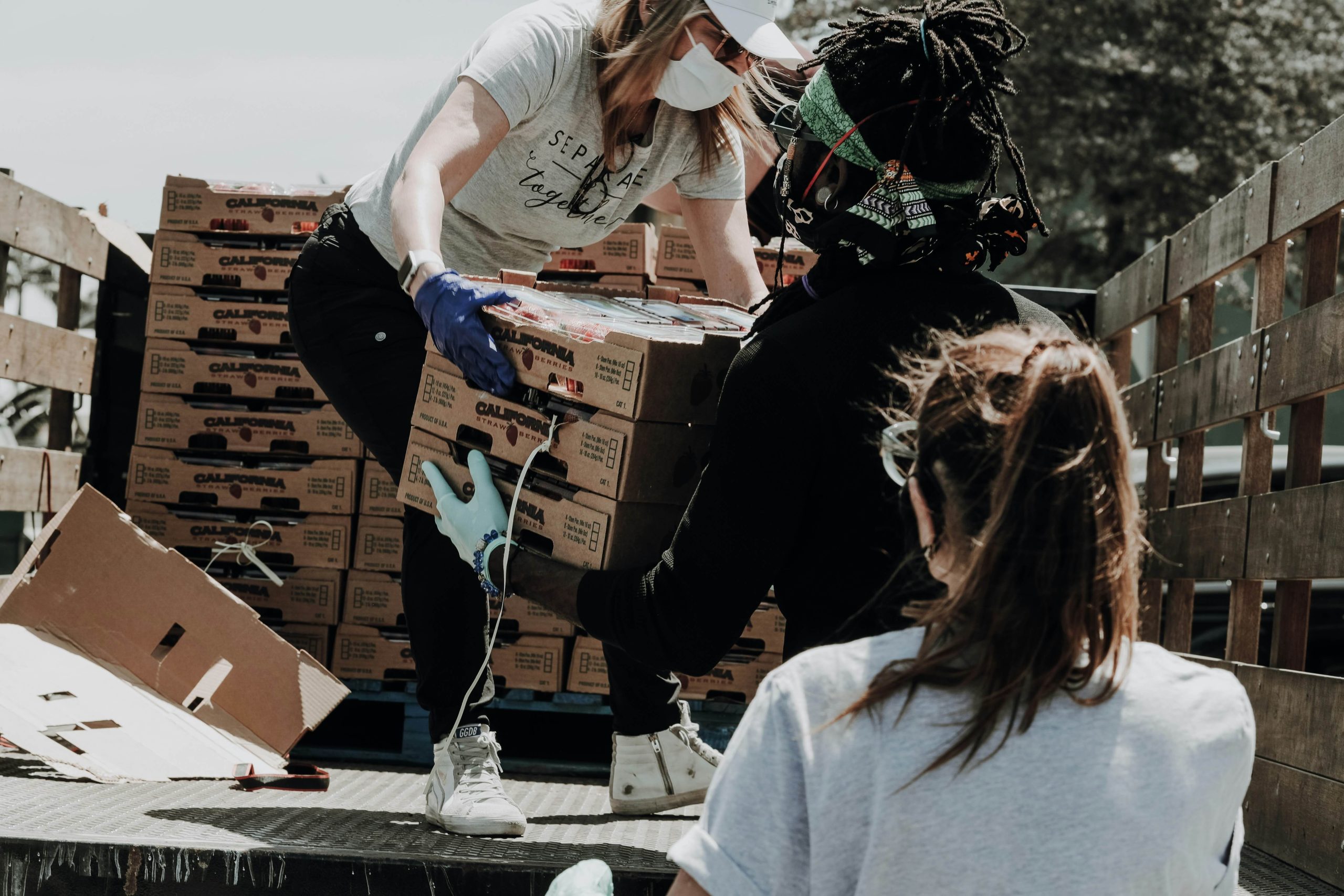 Volunteers unload disaster relief supplies from a truck