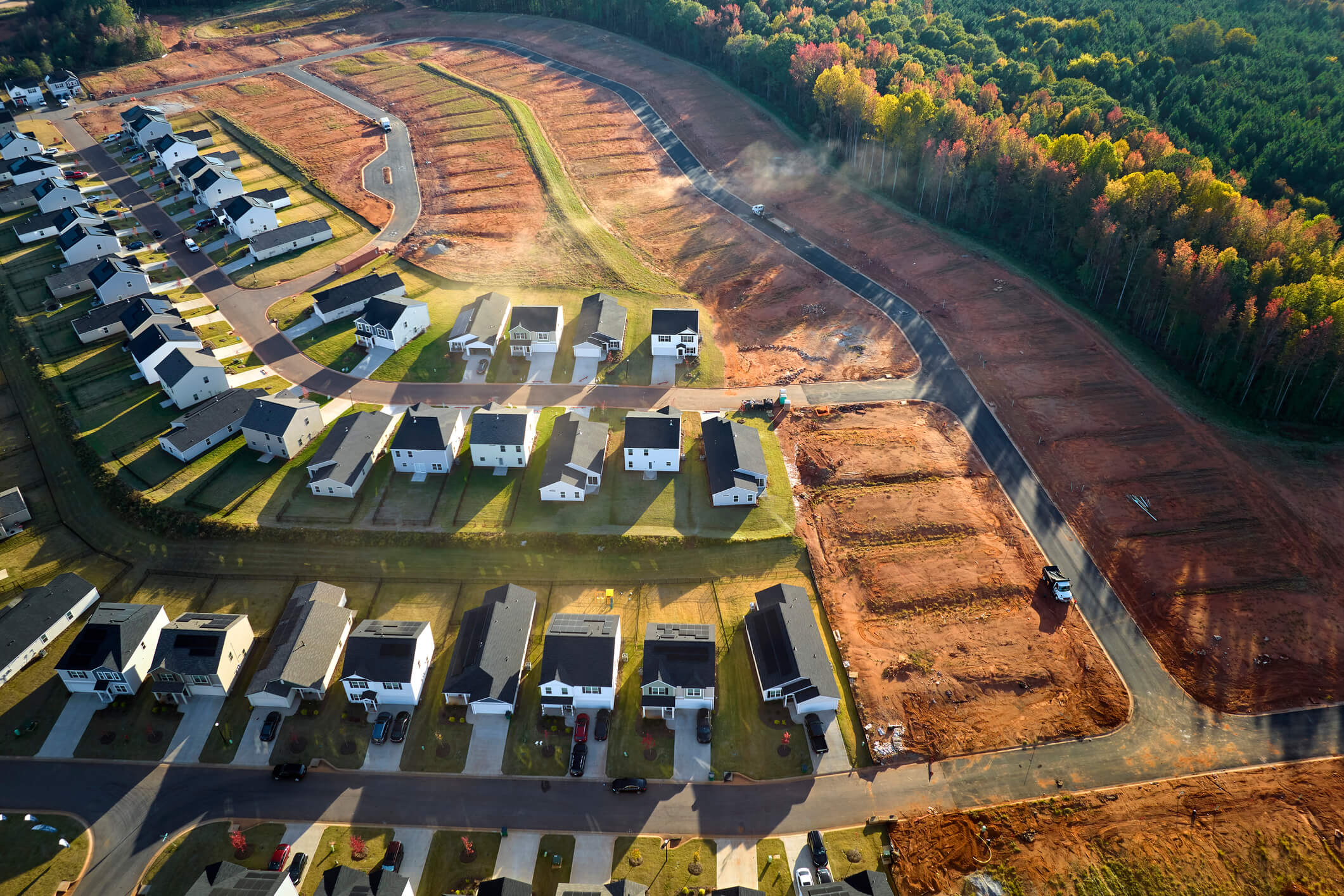 Aerial view of real estate development with tightly located family houses under construction in Carolinas suburban area. Concept of growing American suburbs.